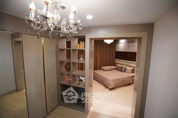 Luxurious bedroom with elegant chandelier and modern shelving