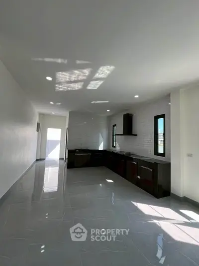 Spacious modern kitchen with sleek design and ample natural light.