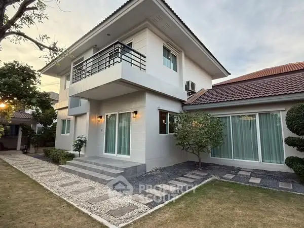 Charming two-story house with modern balcony and landscaped garden in serene neighborhood.