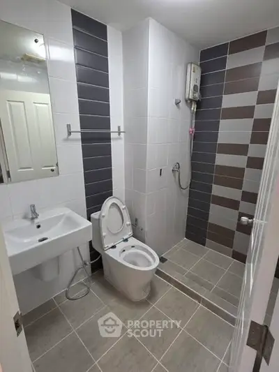 Modern bathroom with sleek design and shower area in contemporary apartment.