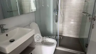 Modern bathroom with sleek fixtures and glass shower enclosure