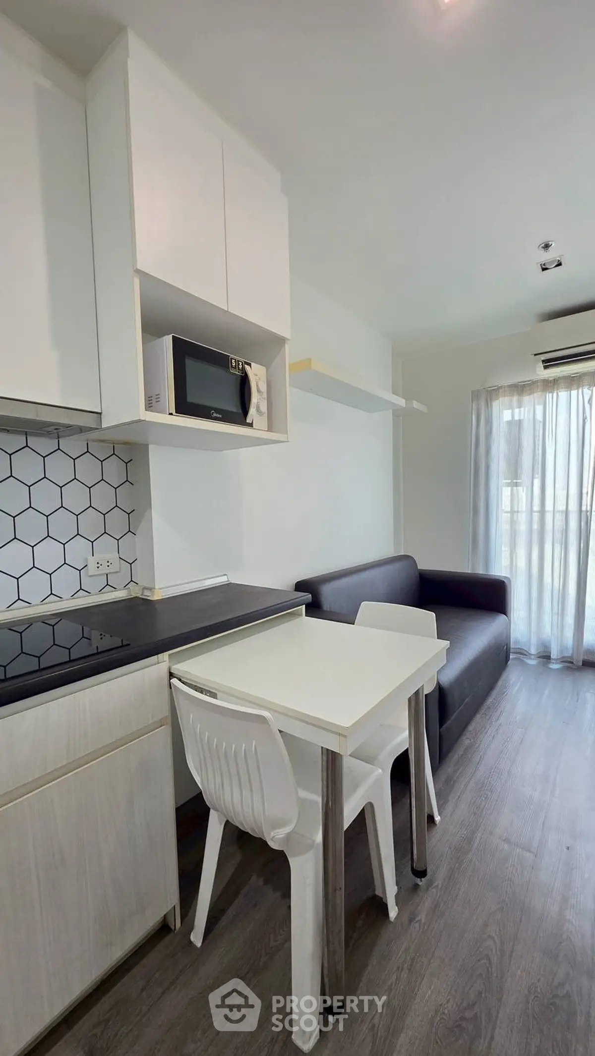 Modern compact living room with kitchenette and natural light