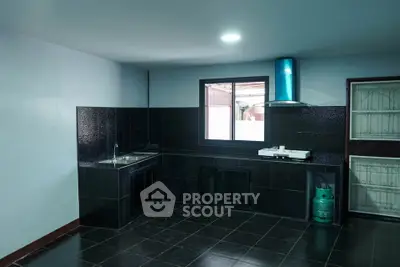 Modern kitchen with sleek black tiles and gas stove