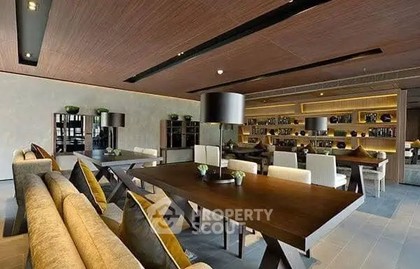 Luxurious modern dining area with elegant wooden tables and ambient lighting in a stylish building.