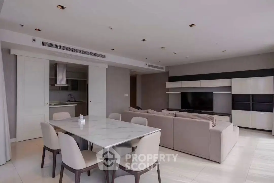 Spacious modern living room with open kitchen and elegant dining area in luxury apartment.
