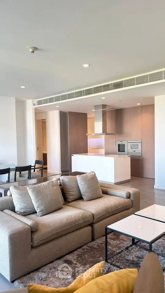 Spacious modern living room with open kitchen and stylish furniture