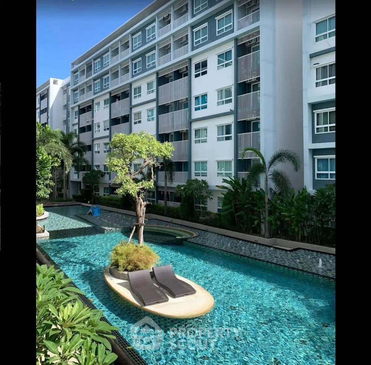 Modern apartment building with luxurious pool and lush greenery