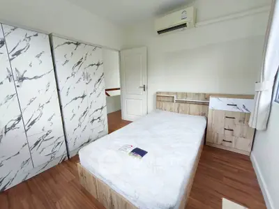 Modern bedroom with marble-patterned wardrobe and wooden flooring