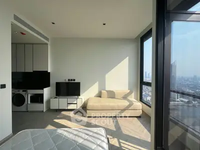 Modern apartment interior with panoramic city view, featuring a cozy living area and built-in appliances.