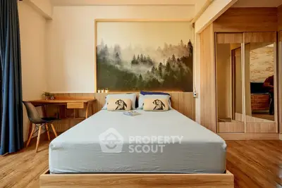 Cozy bedroom with wooden flooring, stylish decor, and a scenic wall mural.