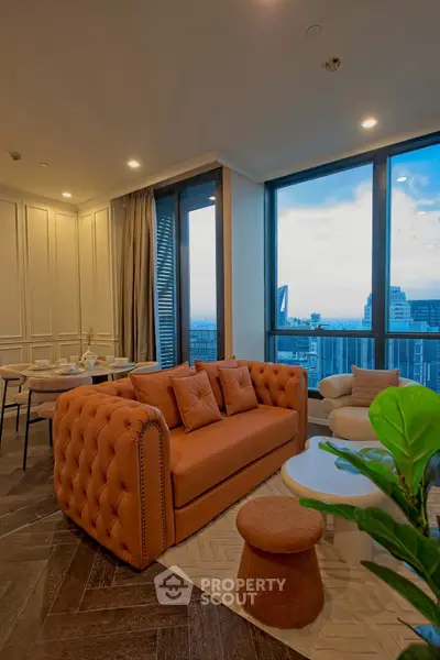 Luxurious living room with stunning city view, elegant furniture, and floor-to-ceiling windows.