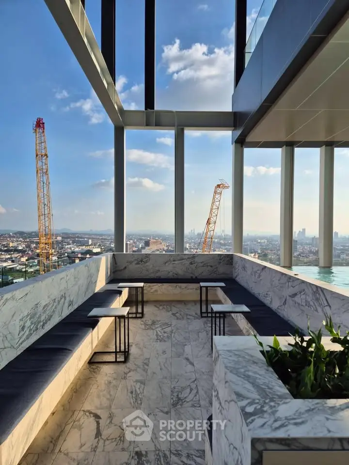 Stunning rooftop view with modern seating and panoramic cityscape, perfect for relaxation and entertainment.