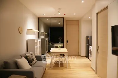 Modern living room with cozy sofa, dining table, and stylish decor in a contemporary apartment.