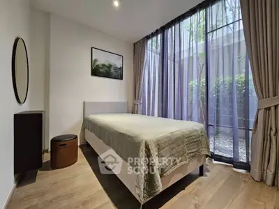 Modern bedroom with large windows and elegant decor