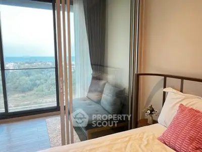 Charming bedroom with a cozy balcony offering a serene view, perfect for relaxation.