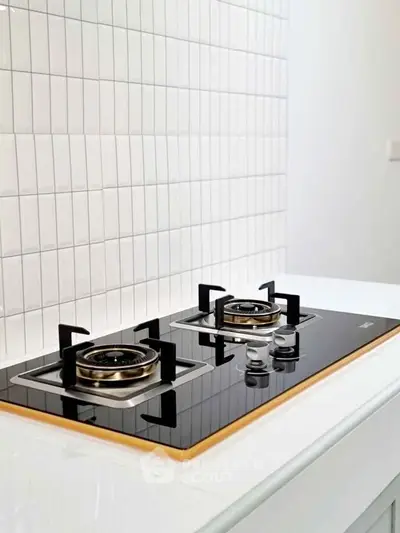 Modern kitchen with sleek gas stove and white tiled backsplash