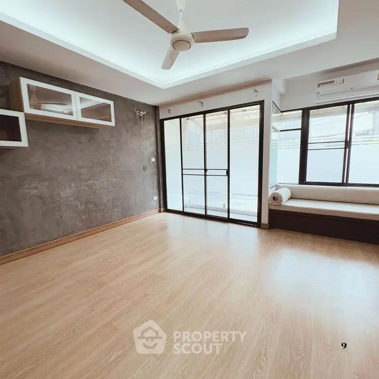 Spacious modern living room with wooden flooring and large windows