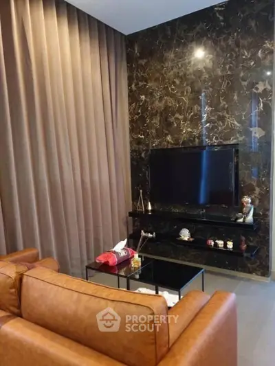 Luxurious living room with elegant marble wall and leather sofa, perfect for modern living.