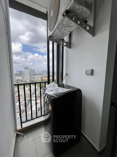High-rise apartment balcony with washing machine and city view