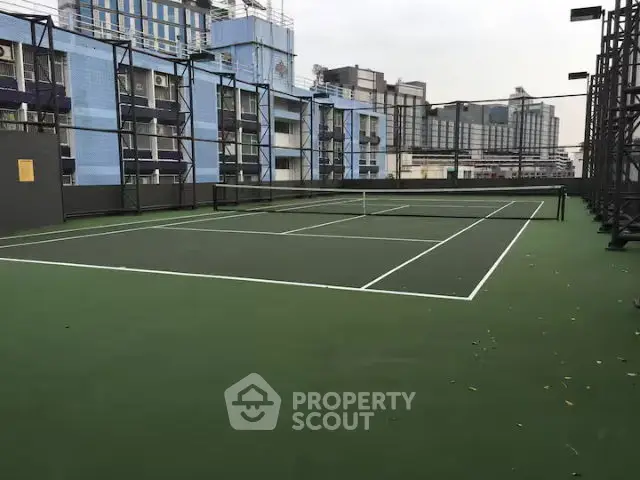 Urban rooftop tennis court with cityscape view