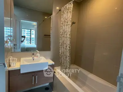 Modern bathroom with bathtub and sleek fixtures in a contemporary apartment.