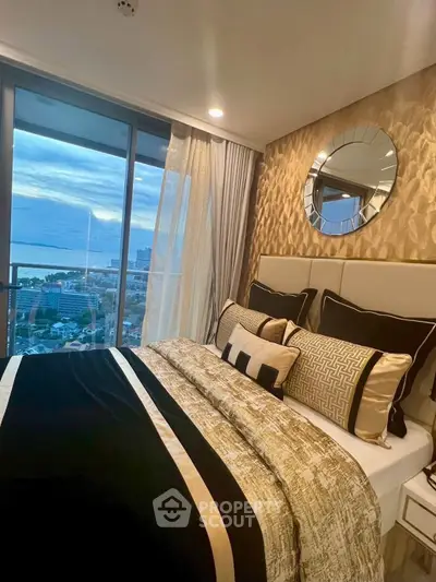 Luxurious bedroom with stunning ocean view and elegant decor in high-rise apartment.