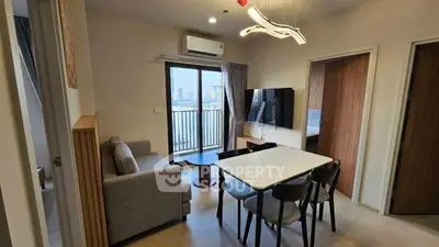 Modern living room with stylish lighting and balcony view in a contemporary apartment.