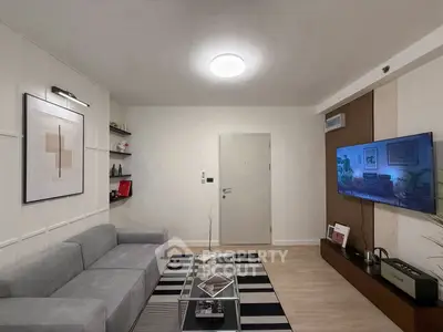 Modern living room with sleek decor and wall-mounted TV, perfect for stylish urban living.