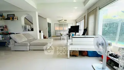 Spacious modern living room with large windows and sleek furniture