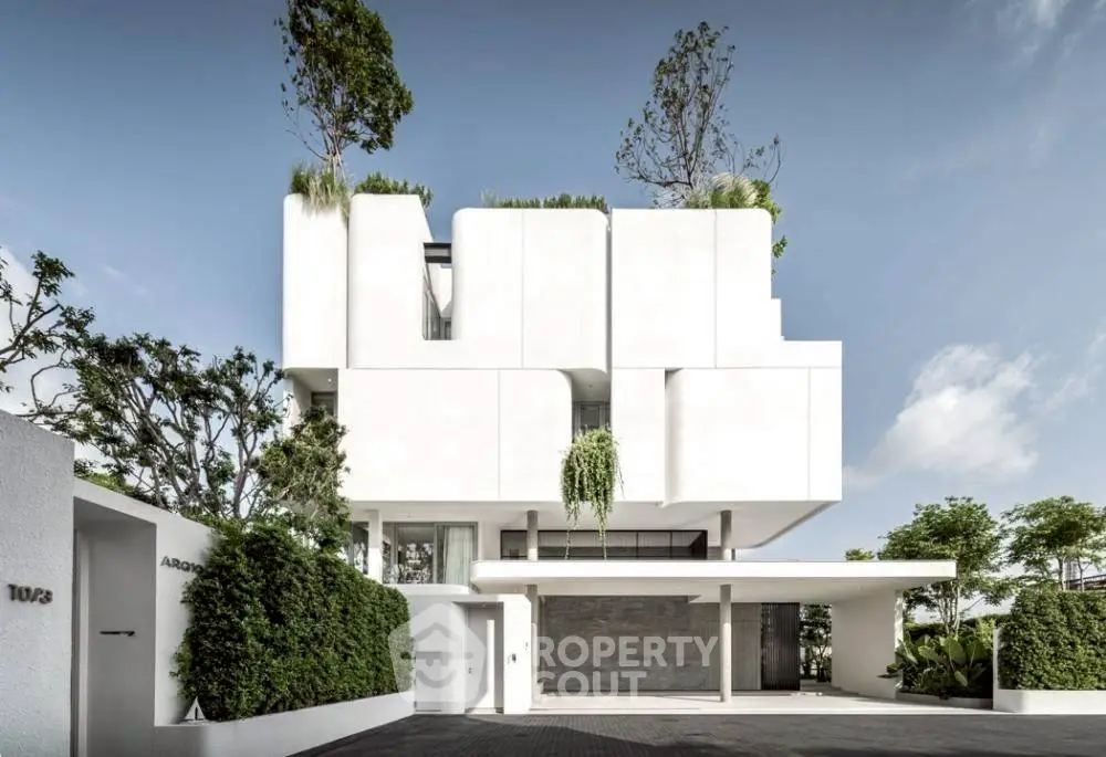 Stunning modern architectural masterpiece with lush greenery and sleek white facade.