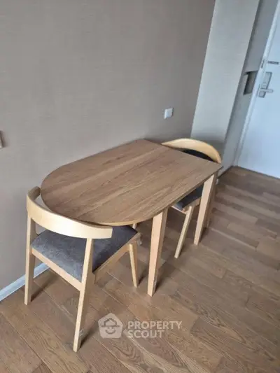 Cozy dining nook with wooden table and chairs in modern apartment