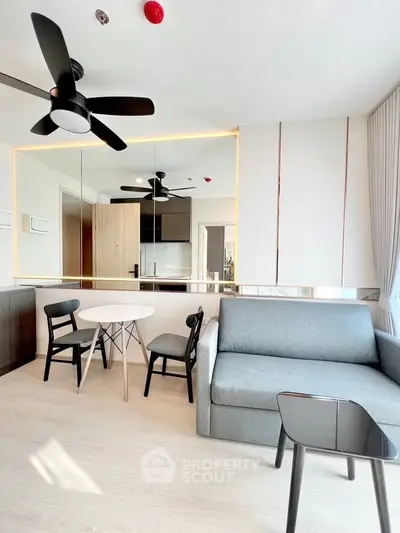 Modern living room with sleek furniture and open kitchen layout