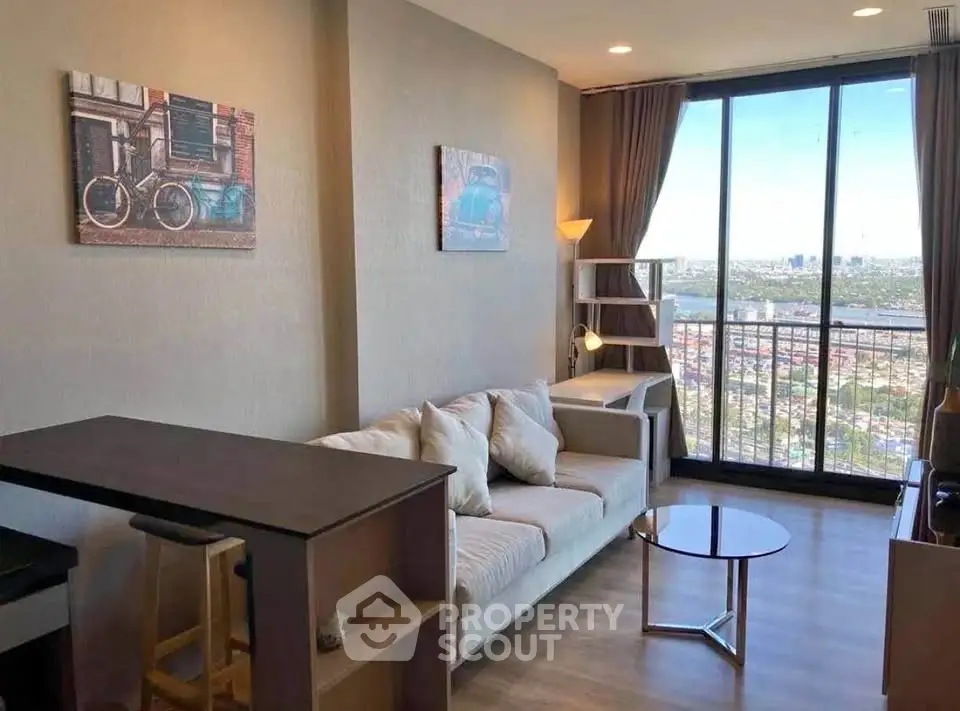 Modern living room with large windows and city view, featuring stylish decor and comfortable seating.