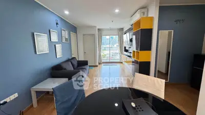 Modern living room with city view, stylish decor, and open layout in a high-rise apartment.