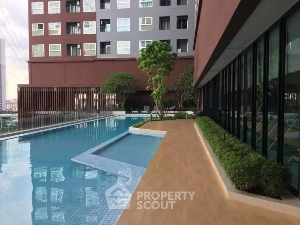Luxurious apartment complex with stunning poolside view and modern architecture.