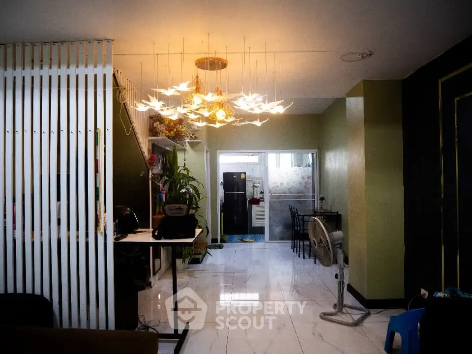 Modern living room with elegant lighting and open layout, featuring stylish decor and spacious design.