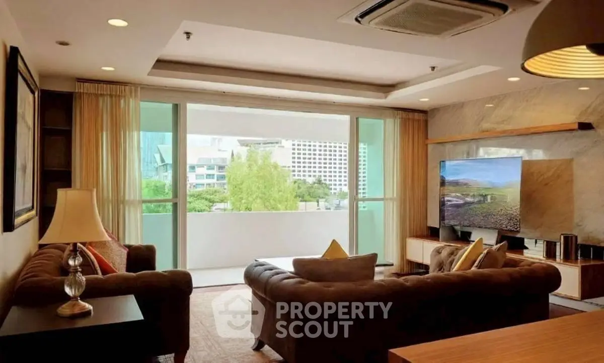 Luxurious living room with modern decor and large balcony view in upscale apartment.