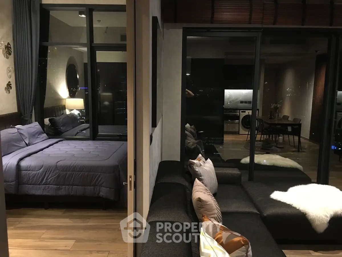 Modern apartment with cozy bedroom and stylish living area, featuring floor-to-ceiling windows and contemporary decor.