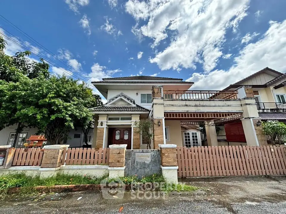 Charming two-story house with spacious balcony and lush garden, perfect for family living in a serene neighborhood.