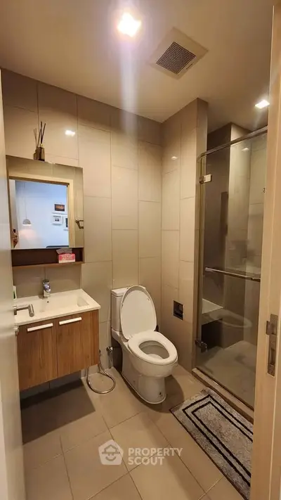 Modern bathroom with sleek fixtures and glass shower enclosure
