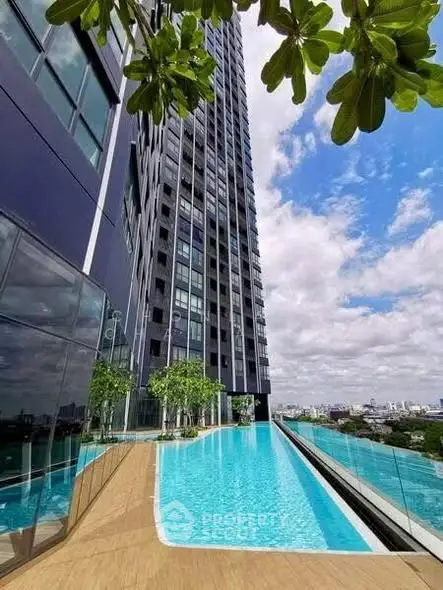 Luxurious high-rise building with stunning rooftop infinity pool and panoramic city views.