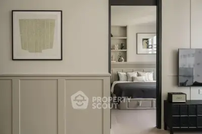 Modern bedroom with stylish decor and wall art, featuring a cozy bed and elegant paneling.