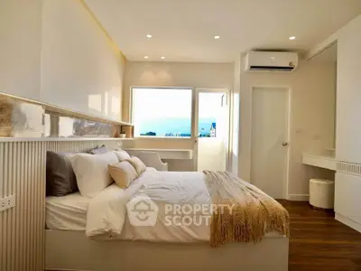 Luxurious bedroom with modern decor and stunning view, featuring cozy bedding and elegant lighting.