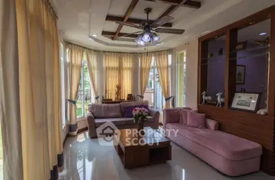 Elegant living room with plush sofas and large windows, perfect for relaxation.