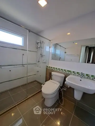 Modern bathroom with glass shower and sleek fixtures