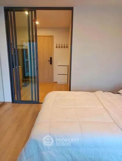 Modern bedroom with sliding glass door and cozy decor
