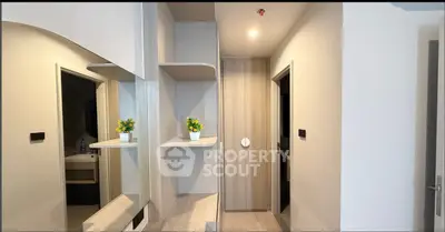 Modern apartment hallway with stylish wooden accents and decorative plants