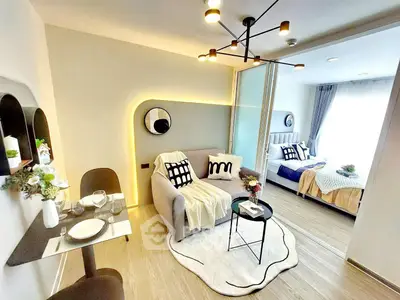 Modern open-plan living room and bedroom with stylish decor and cozy ambiance