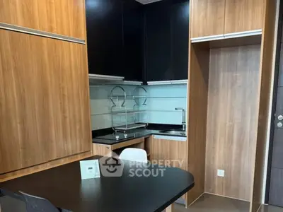 Modern kitchen with sleek wooden cabinets and compact design