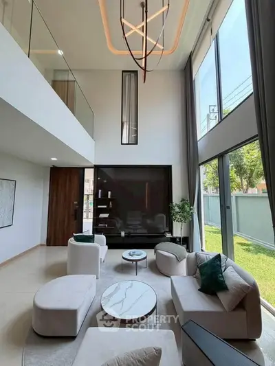 Luxurious modern living room with high ceilings and large windows offering garden views.